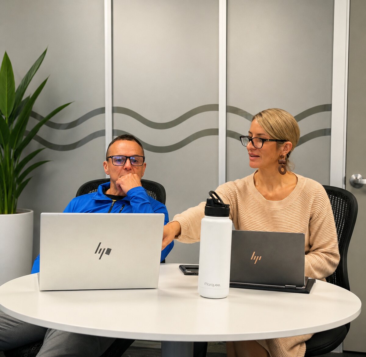 Renée Omand discussing marketing with a client at a meeting table